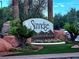 Community sign for Sunridge at MacDonald Ranch featuring colorful flowers and manicured landscaping at 1002 Prestige Meadows Pl, Henderson, NV 89052