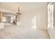 Bright dining room with chandelier and views to living room at 7668 Gossamer Wind St, Las Vegas, NV 89139