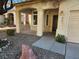 Front porch with a dark brown door and decorative railing at 841 Lusterview Ct, Las Vegas, NV 89123