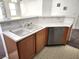 Kitchen sink and stainless steel dishwasher with wood cabinets, and a view into the living room at 841 Lusterview Ct, Las Vegas, NV 89123