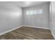 Simple bedroom with hardwood floors and window with shutters at 6019 Clark St, Las Vegas, NV 89122