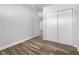 Well-lit bedroom, featuring hardwood floors and mirrored closet at 6019 Clark St, Las Vegas, NV 89122