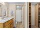 Clean bathroom with wood vanity, shower, and built-in shelving at 687 Marina Dr # 39, Boulder City, NV 89005