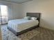 Cozy bedroom with grey upholstered bed and access to balcony at 687 Marina Dr # 39, Boulder City, NV 89005