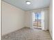 Bright bedroom with carpet flooring and access to balcony at 687 Marina Dr # 39, Boulder City, NV 89005