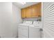 Laundry room with washer, dryer, and overhead cabinets at 687 Marina Dr # 39, Boulder City, NV 89005