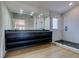 Modern bathroom with a large walk-in shower, double vanity, and dark cabinetry at 7132 Mission Hills Dr, Las Vegas, NV 89113