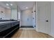 Contemporary bathroom boasting a walk-in shower, double vanity, and light flooring at 7132 Mission Hills Dr, Las Vegas, NV 89113