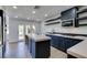 Modern kitchen with island, stainless steel appliances, and dark cabinetry at 7132 Mission Hills Dr, Las Vegas, NV 89113