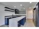 Modern kitchen with dark blue cabinetry, stainless steel appliances, and a large island at 7132 Mission Hills Dr, Las Vegas, NV 89113