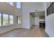 Sunlit living room with hardwood floors and large windows at 7132 Mission Hills Dr, Las Vegas, NV 89113