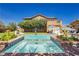 Exterior shot of a backyard pool and spa, with manicured landscaping and outdoor seating areas at 6391 Tempting Choice Ave, Las Vegas, NV 89131