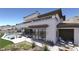 Luxury home featuring a pristine backyard with a sparkling pool, modern patio furniture, and stunning mountain views at 12 Oakmont Hills Ln, Las Vegas, NV 89141