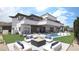 Luxury backyard featuring a modern fire pit, a sparkling pool, and elegant lounge seating at 12 Oakmont Hills Ln, Las Vegas, NV 89141