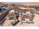Aerial view of a home under construction with a tile roof, surrounded by scaffolding in a residential area at 12 Oakmont Hills Ln, Las Vegas, NV 89141