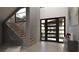 Bright and inviting entryway features tile flooring, modern door, and unique sculptural accents at 12 Oakmont Hills Ln, Las Vegas, NV 89141
