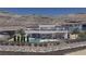 Elegant two-story home showcasing a beautiful pool, outdoor seating, and stunning desert mountain views in the background at 12 Oakmont Hills Ln, Las Vegas, NV 89141