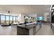 Open floor plan with a gourmet kitchen, dining area, and living room featuring modern design and scenic views at 12 Oakmont Hills Ln, Las Vegas, NV 89141
