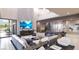 Modern living room with a large TV, fireplace, high ceilings, and an open floor plan at 12 Oakmont Hills Ln, Las Vegas, NV 89141