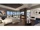 This main bedroom features a fireplace, lounge chairs, and exterior views from floor to ceiling windows at 12 Oakmont Hills Ln, Las Vegas, NV 89141
