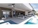 Contemporary patio area with sleek outdoor furniture, overlooking a pool, and seamless transition to indoor living at 12 Oakmont Hills Ln, Las Vegas, NV 89141