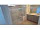 Bathroom featuring a glass shower, double sinks, and modern fixtures at 7086 Parkallen Ave, Las Vegas, NV 89113