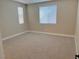 Bright bedroom with neutral carpeting and large window at 7160 Port Stephens St, North Las Vegas, NV 89084