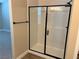 Glass enclosed shower with modern black fixtures at 7160 Port Stephens St, North Las Vegas, NV 89084