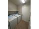 Laundry room with washer, dryer, and built-in shelving at 9804 Panorama Cliff Dr, Las Vegas, NV 89134