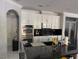 Modern kitchen showcasing an island with dark countertops and stainless steel double ovens at 2742 Kingclaven Dr, Henderson, NV 89044