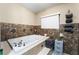 Bathroom with a large soaking tub and tile surround at 442 Republic St, Henderson, NV 89015