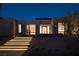 Inviting modern home exterior featuring illuminated walkway, desert landscaping, and sleek architectural details at 6 Rockmount Ct, Henderson, NV 89012