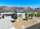 Modern home with desert landscaping, spacious driveway, and beautiful mountain views at 6 Rockmount Ct, Henderson, NV 89012