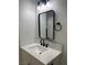 Modern bathroom with white vanity, black matte fixtures, and a black framed mirror at 4313 El Conlon Ave, Las Vegas, NV 89102