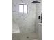 Renovated bathroom features marble shower walls, built-in seat, and modern fixtures at 4313 El Conlon Ave, Las Vegas, NV 89102