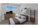 Virtually staged bedroom with a brown bed and wooden dresser at 4313 El Conlon Ave, Las Vegas, NV 89102