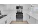 Modern kitchen with white cabinets, stainless steel appliances, and quartz countertops at 4313 El Conlon Ave, Las Vegas, NV 89102