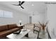 Virtually staged living room with brown leather sofa and coffee table at 4313 El Conlon Ave, Las Vegas, NV 89102