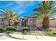 Single-story house with a two-car garage, landscaping, and palm trees at 2731 White Sage Dr, Henderson, NV 89052