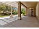 Wide view of the covered patio and landscaping featuring an exterior entry door at 1629 Black Fox Canyon Rd, Henderson, NV 89052