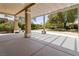 Spacious covered back patio with a concrete floor and a manicured backyard at 1629 Black Fox Canyon Rd, Henderson, NV 89052