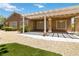 View of the house, covered patio, and manicured backyard at 1629 Black Fox Canyon Rd, Henderson, NV 89052