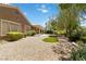 The manicured backyard features trees, lush landscaping, and a covered patio at 1629 Black Fox Canyon Rd, Henderson, NV 89052