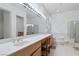 Bathroom boasts a double vanity, large mirror, and separate shower and tub at 1629 Black Fox Canyon Rd, Henderson, NV 89052