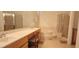 Bathroom featuring dual sinks, a soaking tub, and a separate glass-enclosed shower at 1629 Black Fox Canyon Rd, Henderson, NV 89052