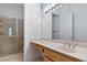Bathroom with a vanity sink, large mirror, and a glass-enclosed shower at 1629 Black Fox Canyon Rd, Henderson, NV 89052