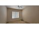 Neutral bedroom with a ceiling fan and bright, shuttered window at 1629 Black Fox Canyon Rd, Henderson, NV 89052