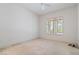 Bedroom with white walls, one window with plantation shutters, and carpet ready for new flooring at 1629 Black Fox Canyon Rd, Henderson, NV 89052