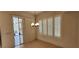 Dining room with plantation shutters, sliding glass door, and decorative chandelier at 1629 Black Fox Canyon Rd, Henderson, NV 89052