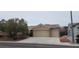 Attractive tan home with a terracotta roof and a spacious three-car garage at 1629 Black Fox Canyon Rd, Henderson, NV 89052